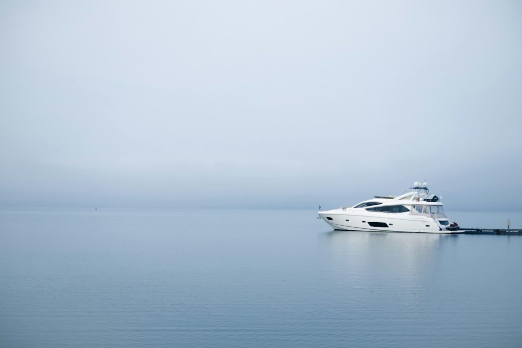 white yacht on body of water